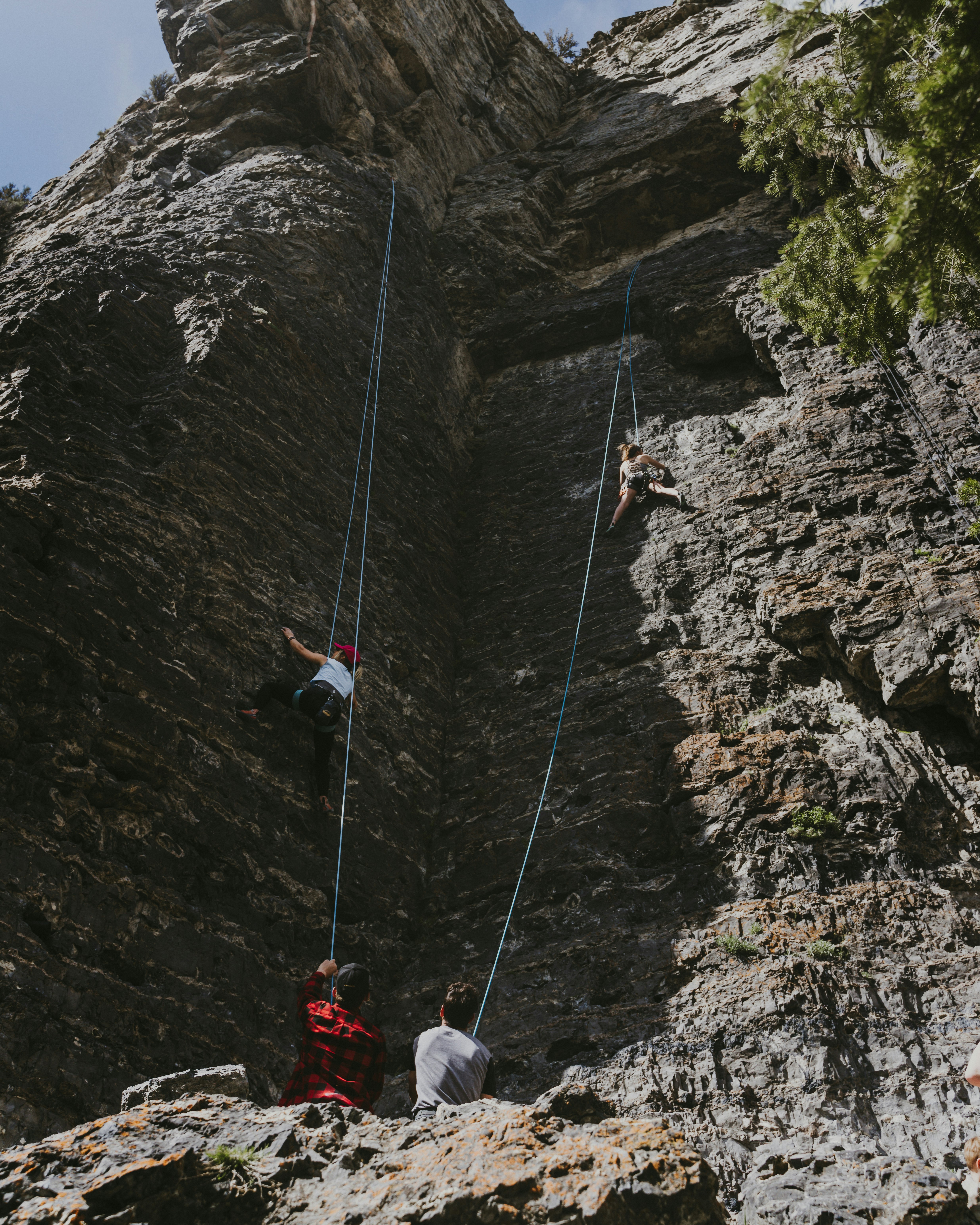 people climbing on mountain during daytime